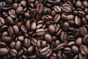 pexels-photo-1695052-1695052 A detailed view of aromatic roasted Arabica coffee beans, highlighting texture and brown color.
