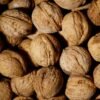 pexels-photo-3640631-3640631 A detailed close-up of fresh unshelled walnuts, ideal for culinary and healthy lifestyle themes.